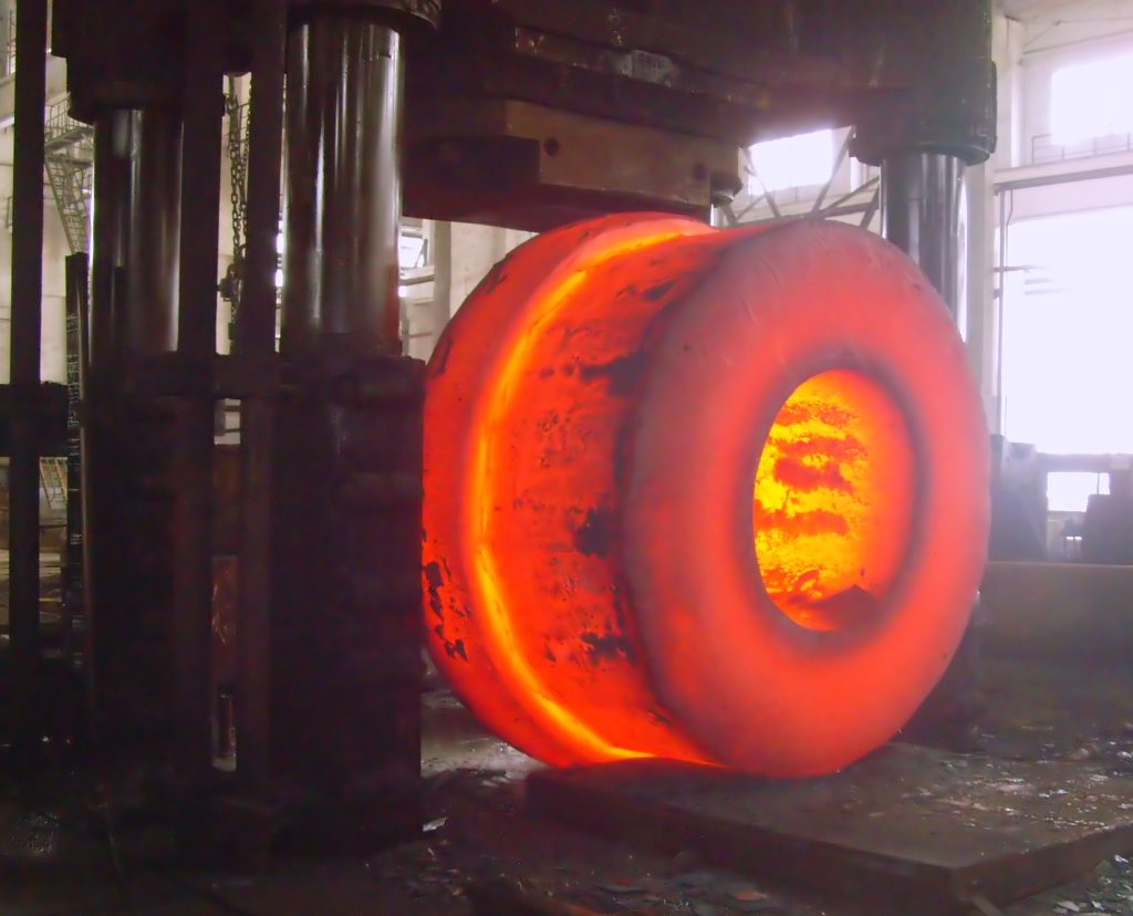 A custom hot-forged steel component, showcasing its complex geometry and dense grain structure.