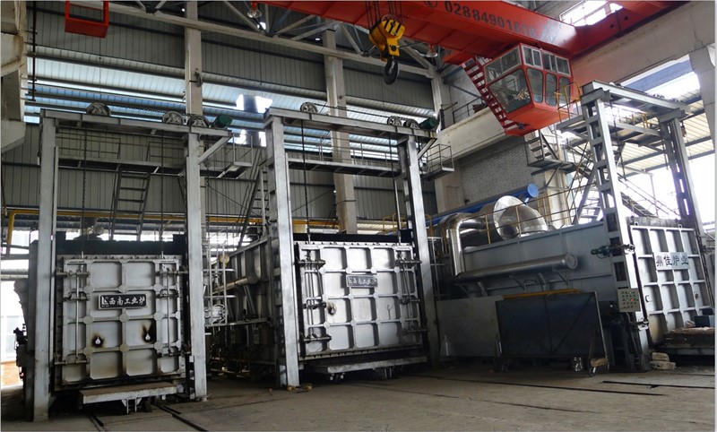 Front view of an industrial box-type heat treatment furnace with a heavy-duty insulated door.