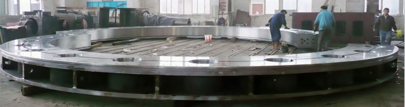The massive rotor of a hydroelectric generator being installed inside a power station powerhouse.