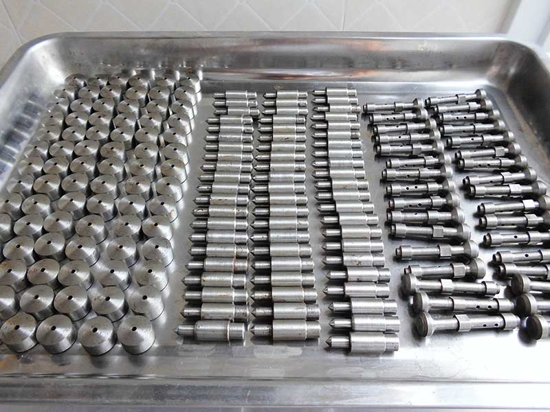 Precision-machined pressure relief valve component for an isostatic press.