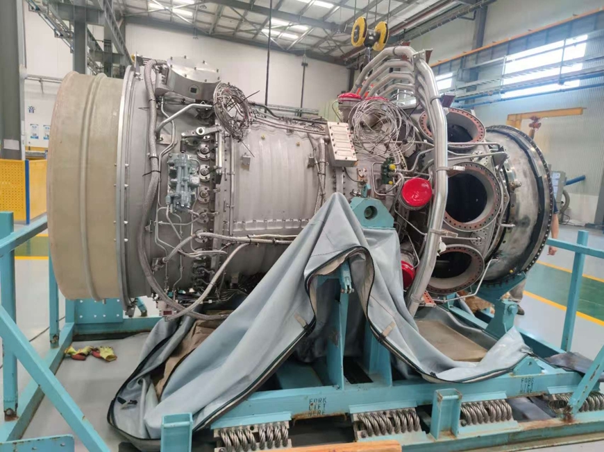 A selection of genuine Rolls-Royce RB211 gas turbine spare parts, including turbine blades and compressor components, ready for shipment.